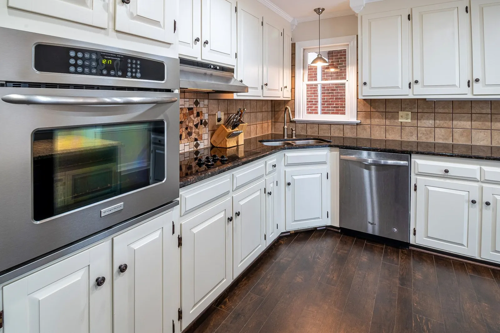 Freshly painted white kitchen cabinets in a Southlake home after professional cabinet painting service