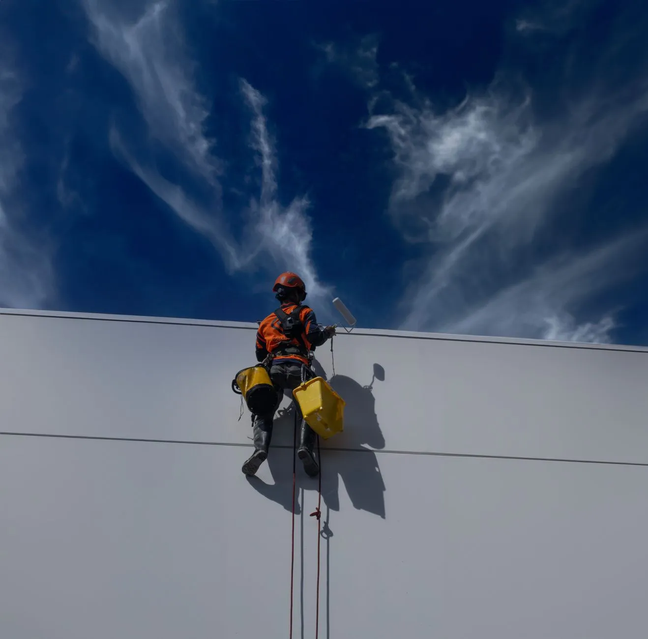 Commercial painting contractor in Fort Worth applying exterior coating to a commercial office building