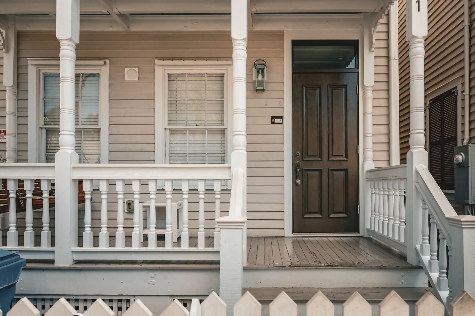 Painter applying fresh exterior paint to a suburban home in Trophy Club Texas with HOA-approved colors